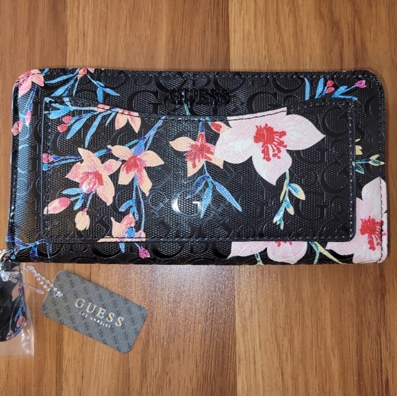 Guess Handbags - Guess- floral zippered wallet with front pocket.